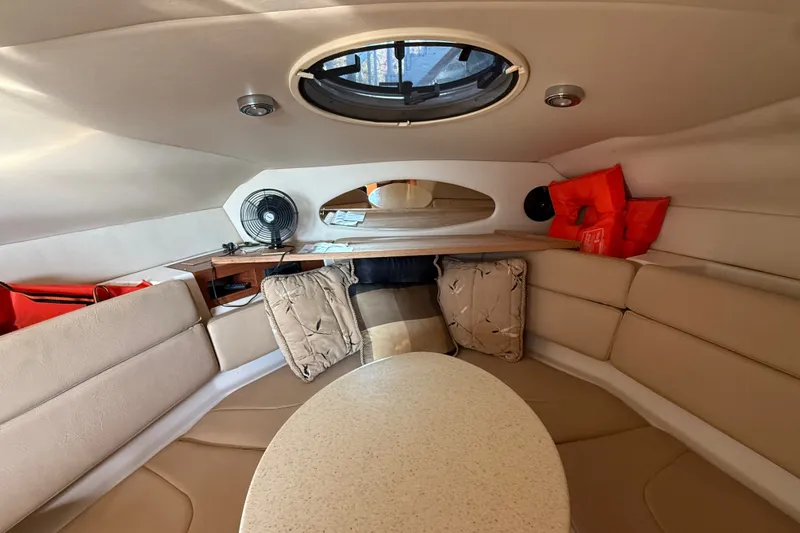 Slide: The Image of Interior of 2007 Regal Commodore 2665 boat with seating, table, and life jackets. - 19
