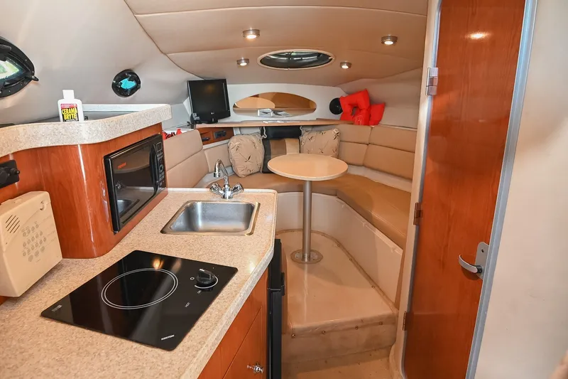Slide: The Image of Interior of 2007 Regal Commodore 2665 boat with kitchenette and seating area. - 24