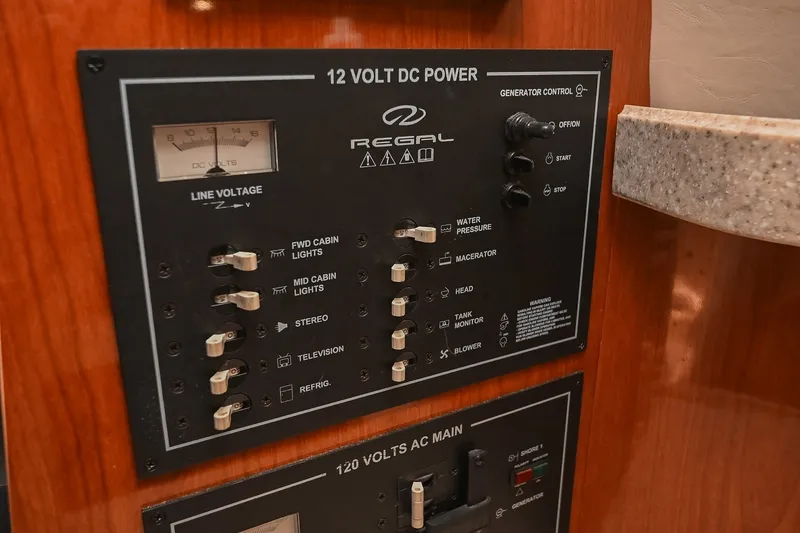 Slide: The Image of Control panel of a 2007 Regal Commodore 2665 boat, featuring 12V DC power switches. - 43