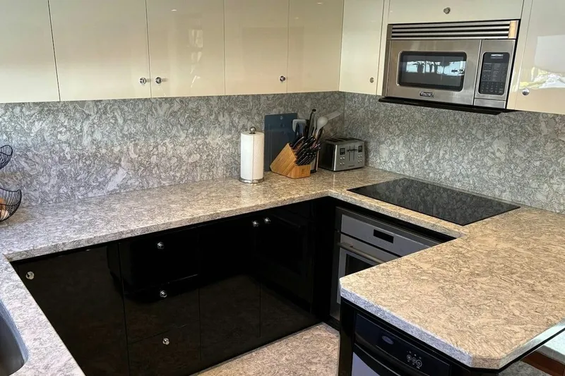 Slide: The Image of Modern kitchen in 2020 Ocean Alexander 100 Skylounge Megayacht with sleek appliances and marble countertops. - 4