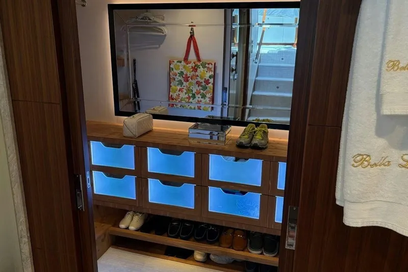 Slide: The Image of Luxurious closet interior on 2020 Ocean Alexander 100 Skylounge Megayacht with illuminated shoe storage. - 14