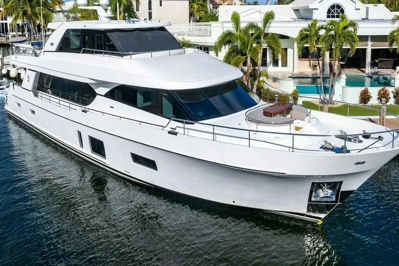 Slide: The Image of Luxurious 2020 Ocean Alexander 100 Skylounge Megayacht docked near waterfront property. - 41