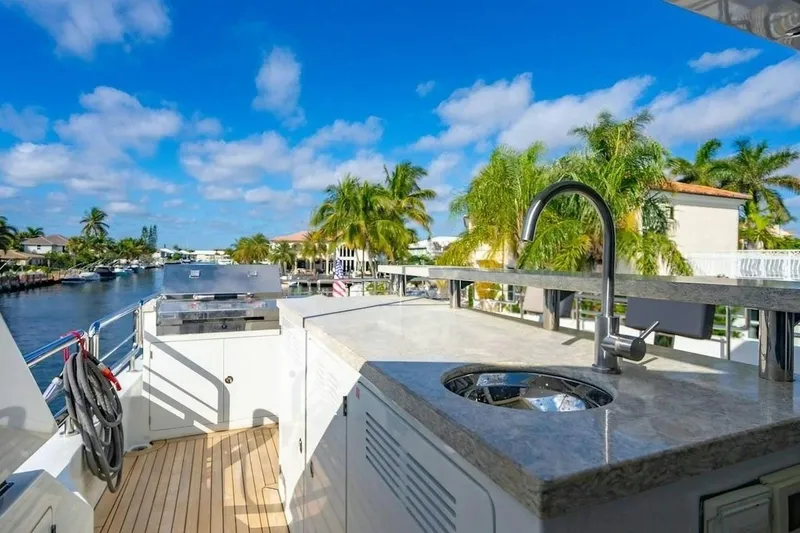 Slide: The Image of Luxurious outdoor kitchen on 2020 Ocean Alexander 100 Skylounge Megayacht, featuring sink and grill. - 34