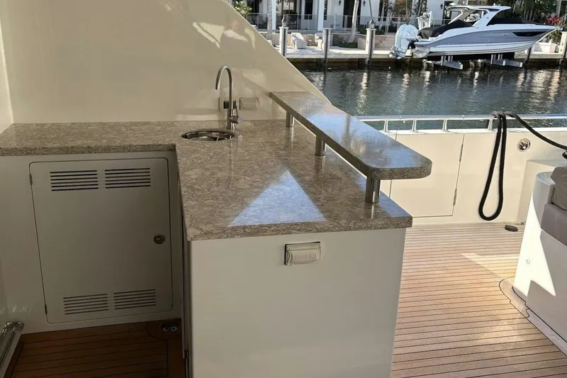 Slide: The Image of Outdoor kitchenette on 2020 Ocean Alexander 100 Skylounge Megayacht, featuring sleek countertop and sink. - 30
