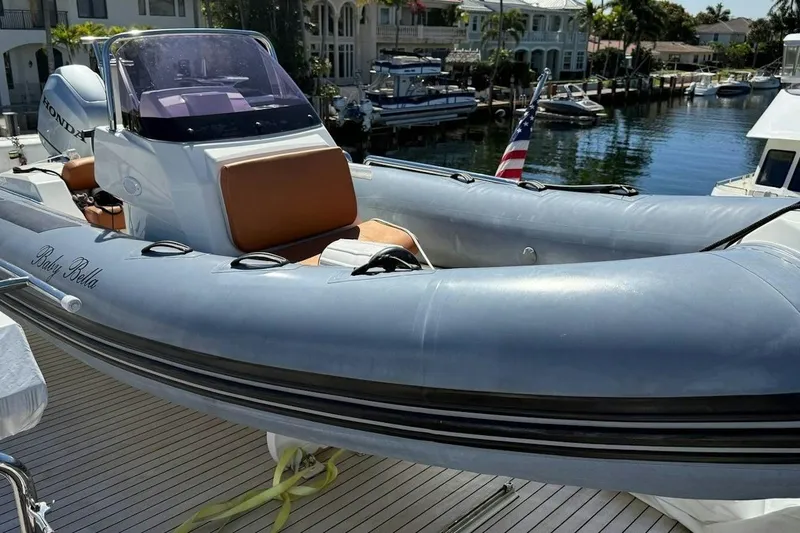 Slide: The Image of 2020 Ocean Alexander 100 Skylounge Megayacht with inflatable tender docked by waterfront homes. - 36