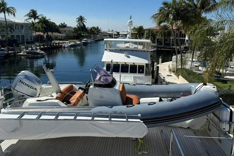 Slide: The Image of 2020 Ocean Alexander 100 Skylounge Megayacht docked with inflatable boat and Honda motor. - 35