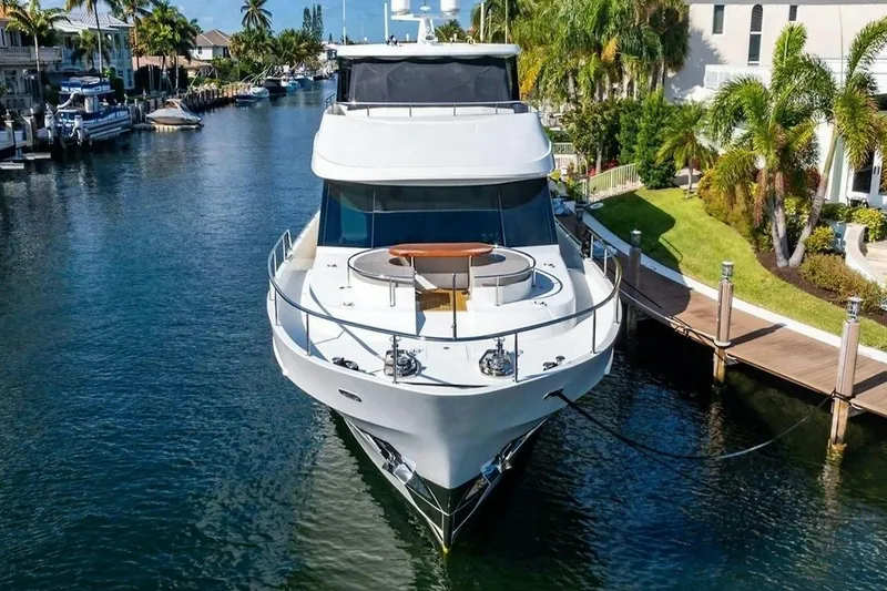 Slide: The Image of 2020 Ocean Alexander 100 Skylounge Megayacht docked in a scenic canal setting. - 40