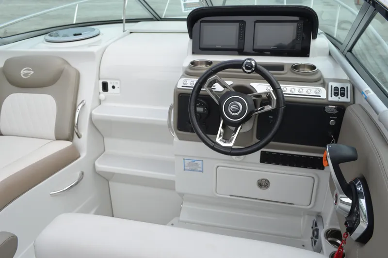 Slide: The Image of 2024 Crownline 270 CR boat cockpit with modern steering and dual displays. - 16