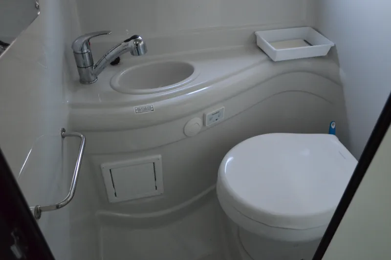Slide: The Image of 2024 Crownline 270 CR boat bathroom with sink and toilet. - 27