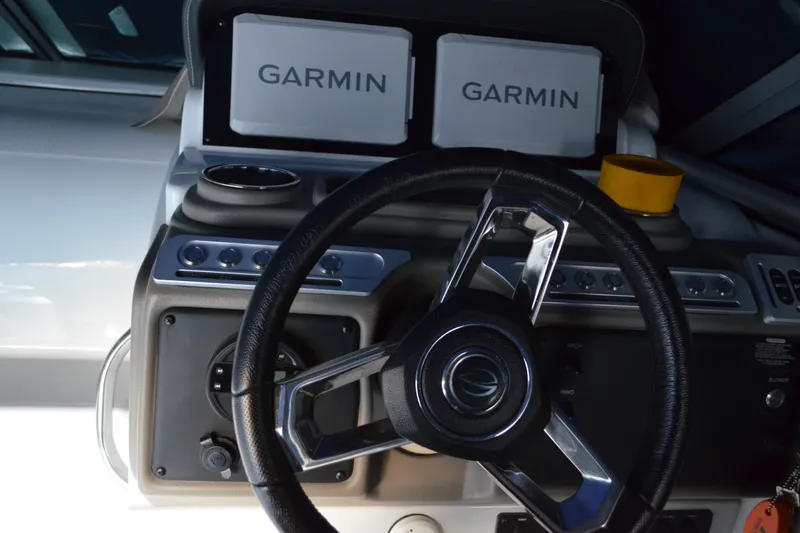 Slide: The Image of 2024 Crownline 270 CR dashboard with Garmin navigation displays and steering wheel. - 15