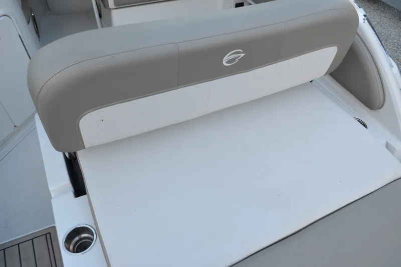 Slide: The Image of 2024 Crownline 270 CR boat seating area with cup holder and cushioned backrest. - 9