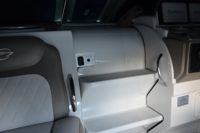 Slide: The Image of 2024 Crownline 270 CR interior with seating and Garmin navigation system. - 12
