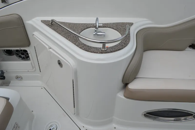Slide: The Image of 2024 Crownline 270 CR boat interior with sink and seating area. - 8