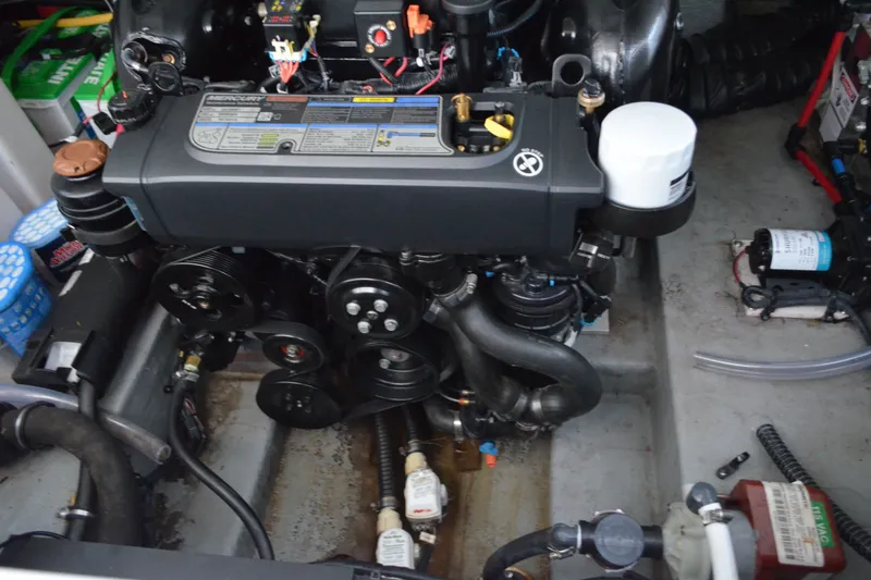 Slide: The Image of Engine compartment of a 2024 Crownline 270 CR boat, showcasing mechanical components. - 33