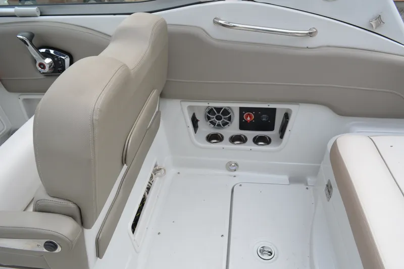 Slide: The Image of 2024 Crownline 270 CR boat interior with beige seating and control panel. - 10