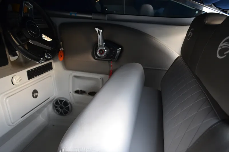 Slide: The Image of 2024 Crownline 270 CR boat interior with steering wheel and seating area. - 13