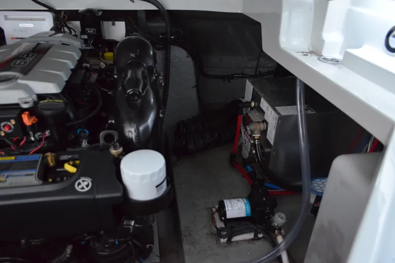 Slide: The Image of Engine compartment of 2024 Crownline 270 CR boat, showcasing mechanical components and wiring. - 34