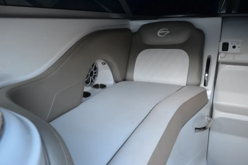 Slide: The Image of 2024 Crownline 270 CR boat interior seating with cup holders and speaker. - 11