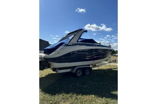 Slide: The Image of 2024 Crownline 270 CR boat on trailer under clear blue sky. - 37