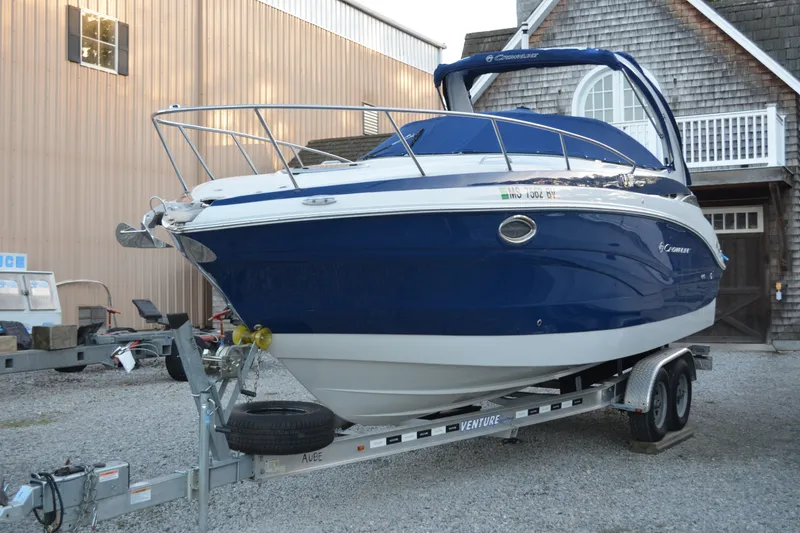 The Image of 2024 Crownline 270 CR boat on trailer, parked outside a building. - 0