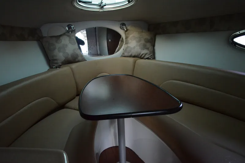 Slide: The Image of 2024 Crownline 270 CR cabin interior with cozy seating and table. - 20