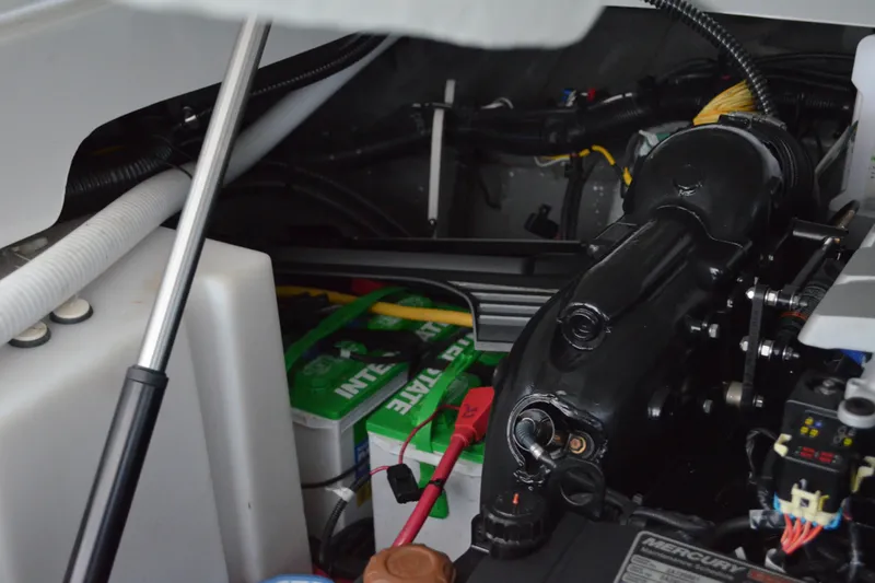 Slide: The Image of Engine compartment of 2024 Crownline 270 CR boat, featuring battery and mechanical components. - 35