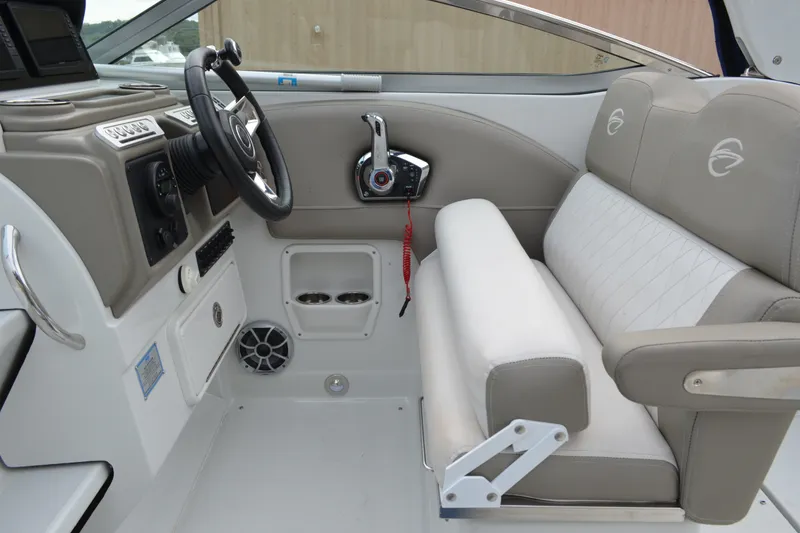 Slide: The Image of 2024 Crownline 270 CR boat interior with steering wheel and seating area. - 15