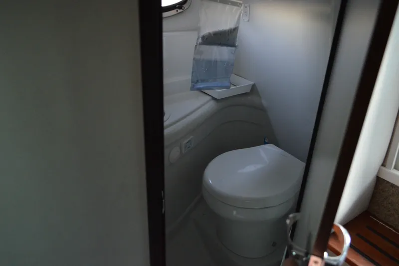Slide: The Image of 2024 Crownline 270 CR boat bathroom interior with modern toilet design. - 28