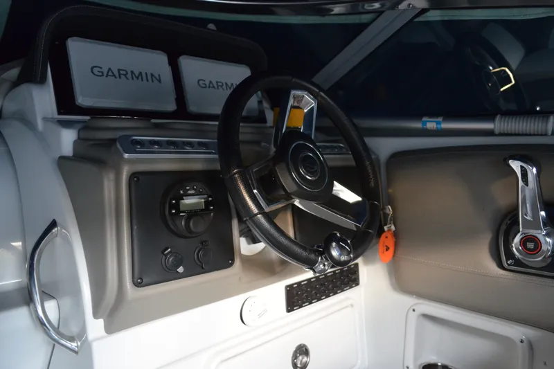 Slide: The Image of 2024 Crownline 270 CR boat dashboard with Garmin displays and steering wheel. - 14