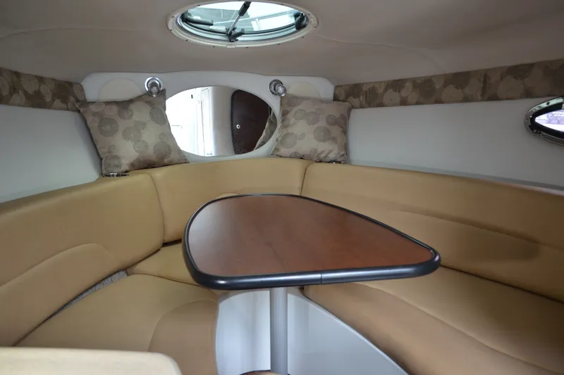 Slide: The Image of Interior of 2024 Crownline 270 CR boat with cozy seating and wooden table. - 23