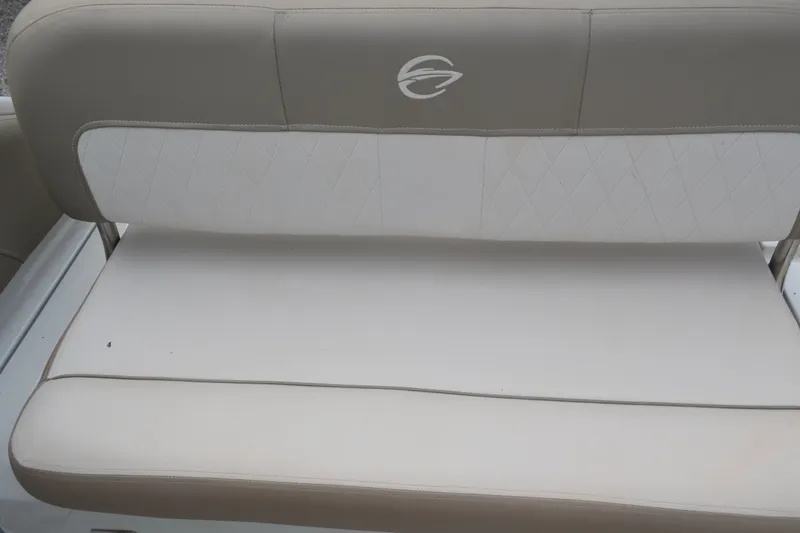 Slide: The Image of 2024 Crownline 270 CR boat seat with beige and white upholstery, featuring a diamond pattern. - 13