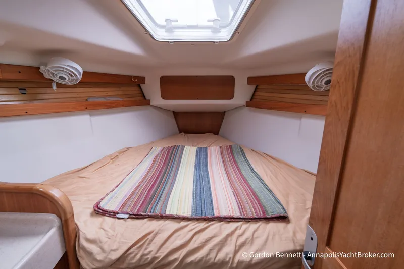 Slide: The Image of Cabin interior of 2003 Catalina 380 yacht with cozy bed and striped blanket. - 43