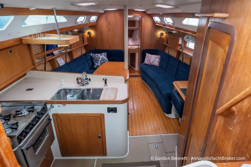 Slide: The Image of Interior of a 2003 Catalina 380 yacht featuring a cozy kitchen and seating area. - 3