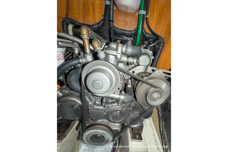 Slide: The Image of Engine of a 2003 Catalina 380 sailboat, showcasing belts and hoses. - 59