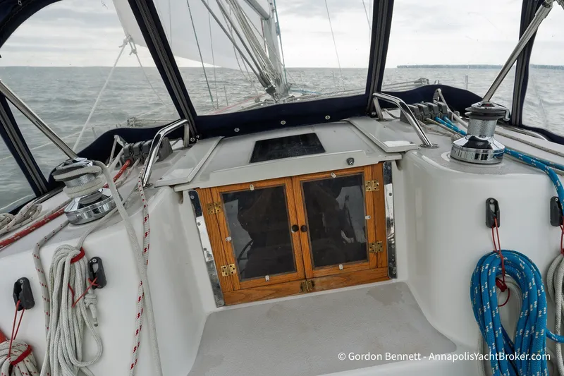 Slide: The Image of Cockpit of 2003 Catalina 380 sailboat with ropes and winches on a cloudy day. - 27