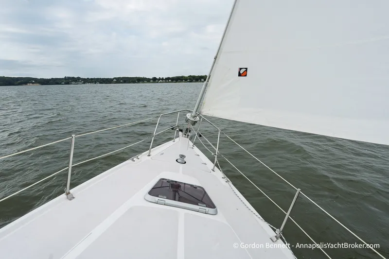 Slide: The Image of Sailing on a 2003 Catalina 380 yacht, view from the deck over calm waters. - 12