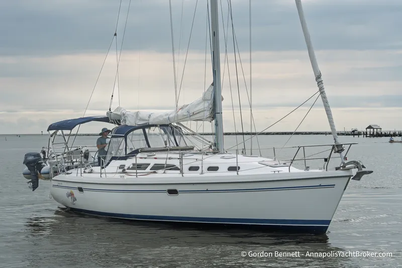 Slide: The Image of 2003 Catalina 380 sailboat on calm waters under cloudy skies. - 0