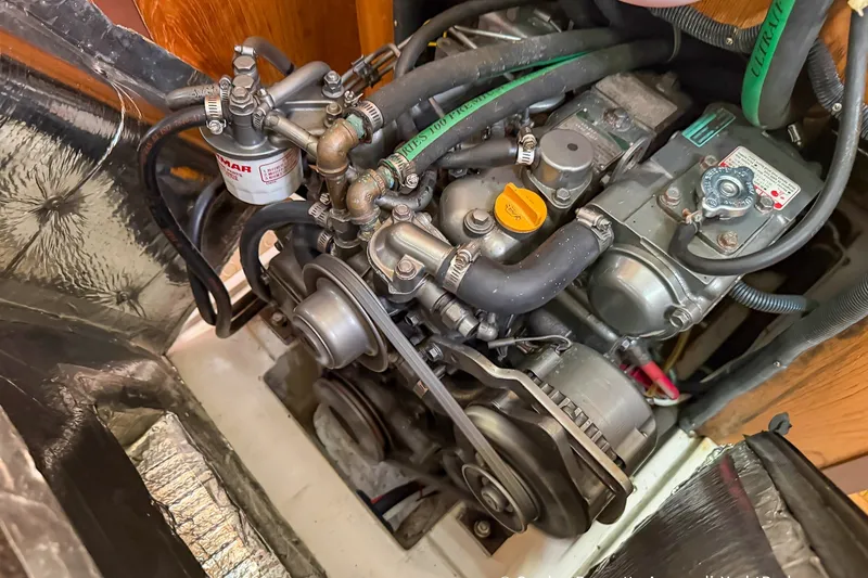 Slide: The Image of Engine compartment of a 2003 Catalina 380 sailboat, showcasing detailed mechanical components. - 58