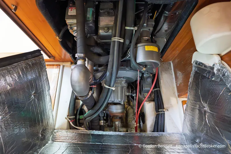 Slide: The Image of Engine compartment of a 2003 Catalina 380 sailboat, showcasing mechanical components and insulation. - 60