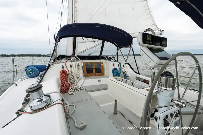 Slide: The Image of 2003 Catalina 380 sailboat cockpit with navigation equipment and ropes on a calm sea. - 22