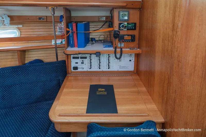 Slide: The Image of Navigation station inside a 2003 Catalina 380 yacht, featuring control panels and communication equipment. - 32