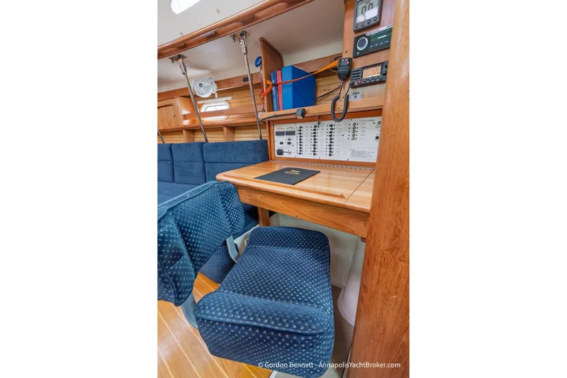 Slide: The Image of Interior of 2003 Catalina 380 yacht with navigation station and blue seating. - 31