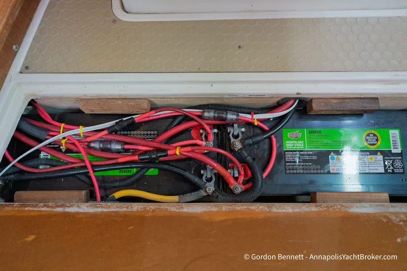 Slide: The Image of Battery compartment of a 2003 Catalina 380 yacht with wiring and deep cycle battery. - 56