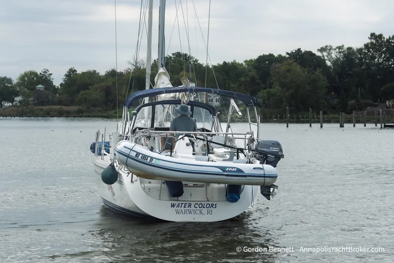 Slide: The Image of Catalina 380 sailboat from 2003, named "Water Colors," docked on a calm river. - 8
