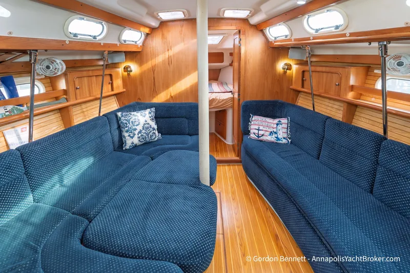 Slide: The Image of Interior of 2003 Catalina 380 yacht with blue seating and wooden accents. - 40