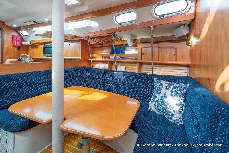 Slide: The Image of Interior of 2003 Catalina 380 yacht with cozy seating and wooden table. - 36