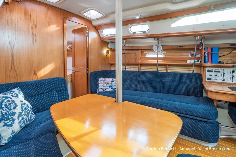 Slide: The Image of Interior of 2003 Catalina 380 yacht with blue seating and wooden table. - 37