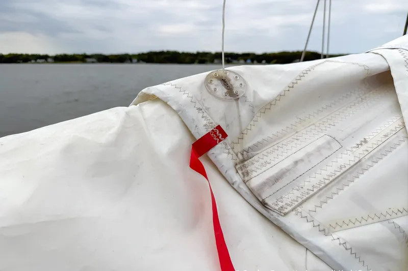 Slide: The Image of Close-up of a Catalina 380 sailboat's sail with red telltale, 2003 model. - 18