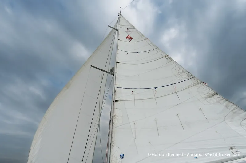 Slide: The Image of Sailing yacht Catalina 380 (2003) with full sails against a cloudy sky. - 2