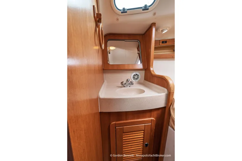 Slide: The Image of Catalina 380 yacht bathroom interior with wooden cabinetry and compact sink, 2003 model. - 45